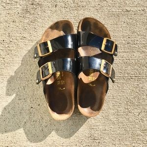 black patent birkenstocks with gold buckle